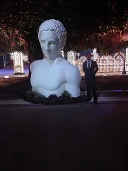 Un busto di marmo illuminato, di sera, durante un evento